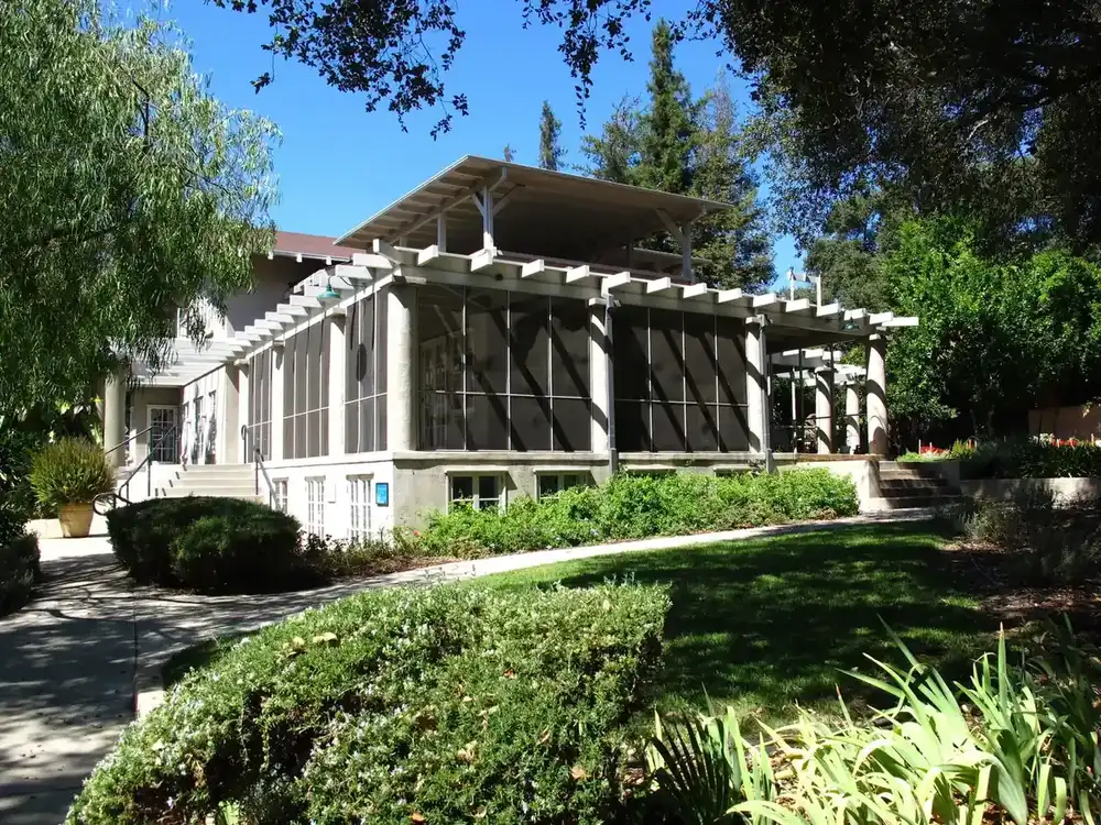 a large screened porch across the front of an older house